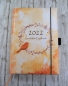 Mobile Preview: personalisierter Buchkalender mit Kranz und Vogel in Orange und Gelb